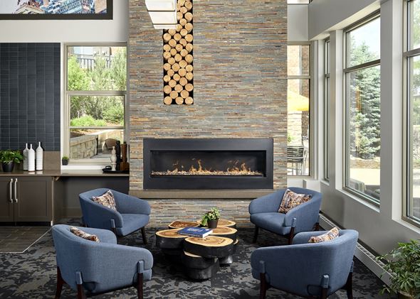 Englewood apartment for rent - Resident lounge with a fireplace and community seating at Zenith Meridian apartments in Englewood.