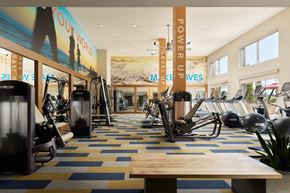 Laguna Hills apartment for rent - A gym with a variety of equipment and a sign that says "Your World".