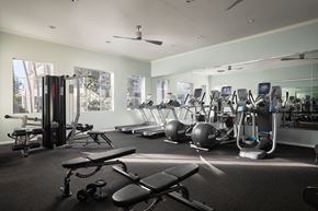 San Diego apartment for rent - A gym with a variety of equipment including treadmills, weights, and exercise balls at Valentia Apartments in La Jolla.