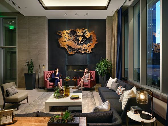 Denver apartment for rent - The lobby fireplace amenity with cozy seating at The Quincy in Downtown Denver.