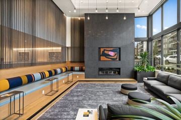Seattle apartment for rent - A modern living room with a fireplace and a large painting above it.