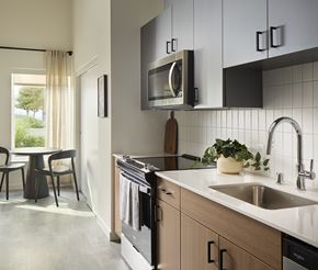 Shoreline apartment for rent - A model kitchen with wood floors and updated appliances at Verdant Apartments in Shoreline.