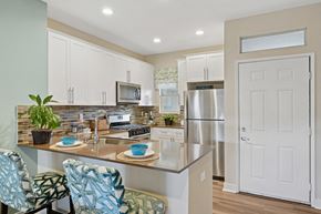 Dublin apartment for rent - A model kitchen with granite counter tops, stainless steel appliances, and counter seating at Park Sierra at Iron Horse Trail in Dublin.