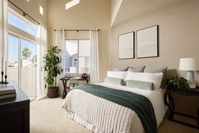 San Diego apartment for rent - A bedroom with a large bed and a desk with a chair at Valentia Apartments in La Jolla.
