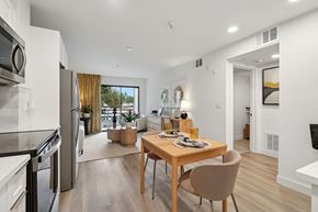 San Jose apartment for rent - A model unit kitchen dining room area with a table and chairs at Elan at River Oaks in San Jose.