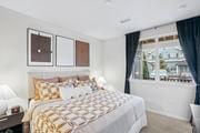 Highlands Ranch apartment for rent - A bedroom with a large bed and a window overlooking a balcony.