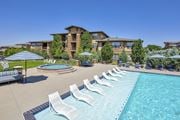 Englewood apartment for rent - Resort-style pool with chaise lounge chairs and umbrellas at Zenith Meridian apartments in Englewood.