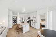 Englewood apartment for rent - A modern kitchen with white cabinets and a wooden table.