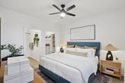 Englewood apartment for rent - A bedroom with a large bed and a ceiling fan.