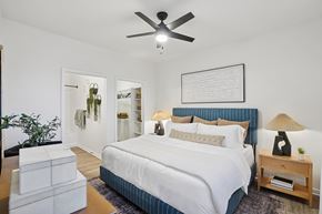 Englewood apartment for rent - A bedroom with a large bed and a ceiling fan.