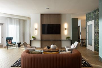 Shoreline apartment for rent - A living room with a brown couch and a flat screen TV.