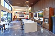 Northridge apartment for rent - Kitchen with TVs and bar style seating at Symmetry apartments in Northridge.