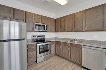 Englewood apartment for rent - A kitchen with wooden cabinets and stainless steel appliances.
