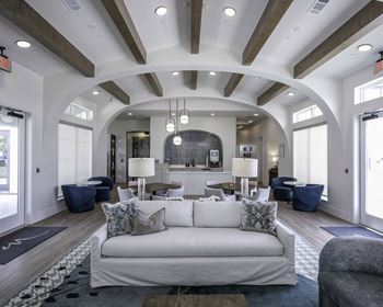 Expansive clubhouse equipped with fireplace, entertainment space, coworking spaces, and a landscaped patio