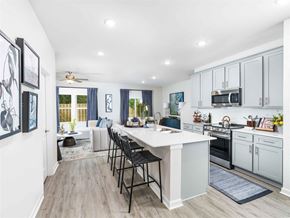 Hoschton apartment for rent - A kitchen with a white countertop and black chairs.