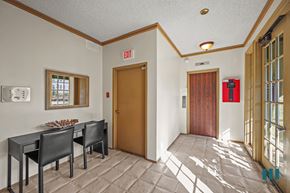 Los Angeles apartment for rent - A conference room with a table and chairs and an exit sign on the wall.