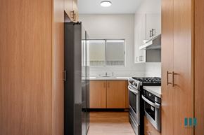 Los Angeles apartment for rent - a kitchen with wood cabinets and stainless steel appliances and a refrigerator
