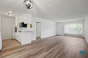Los Angeles apartment for rent - A spacious living room with wooden flooring and white walls.