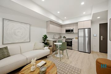 Los Angeles apartment for rent - A modern kitchen with a dining table and chairs, a couch, and a painting on the wall.