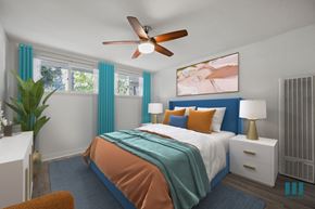 Los Angeles apartment for rent - A bedroom with a bed, a ceiling fan, and a painting on the wall.