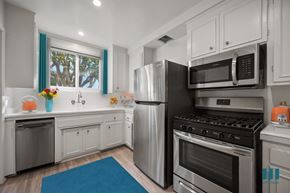 Los Angeles apartment for rent - A modern kitchen with stainless steel appliances and white cabinets.