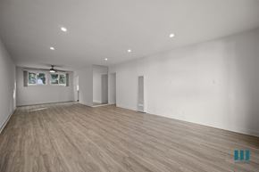 Los Angeles apartment for rent - A spacious room with wooden flooring and white walls.