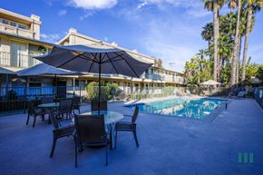 Los Angeles apartment for rent - A pool area with chairs and umbrellas is shown.