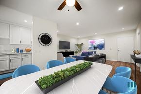 Los Angeles apartment for rent - a dining room with a white table and blue chairs