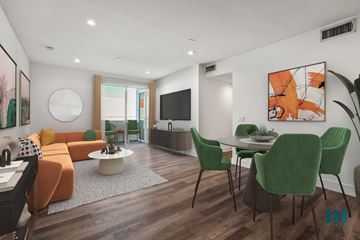 Los Angeles apartment for rent - a living room with a couch and a table with chairs