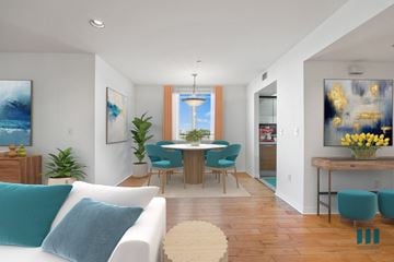 Los Angeles apartment for rent - A living room with a white couch and a dining table.