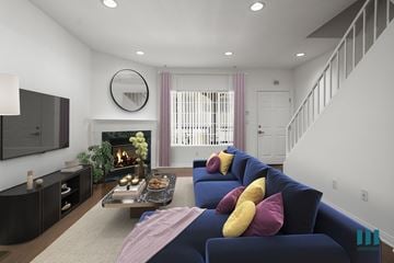 Los Angeles apartment for rent - A living room with a blue couch and a fireplace.