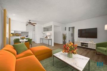 Los Angeles apartment for rent - A living room with a white sofa and a green armchair.