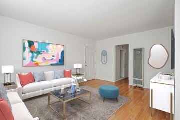 Los Angeles apartment for rent - A living room with a white couch, a glass coffee table, and a painting on the wall.