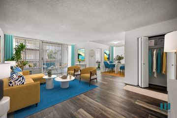 Los Angeles apartment for rent - A living room with a yellow couch and a blue rug.
