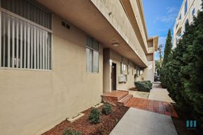 Los Angeles apartment for rent - A building with a red brick pathway leading to the entrance.