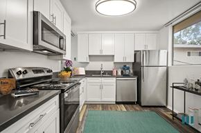 Los Angeles apartment for rent - A modern kitchen with white cabinets and stainless steel appliances.