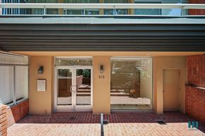 Los Angeles apartment for rent - The image shows a building entrance with a glass door and a number 818 on it.