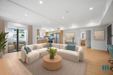 Los Angeles apartment for rent - A living room with a large white sofa and a coffee table in the center.