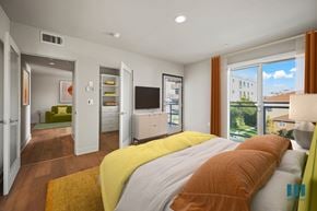 Los Angeles apartment for rent - Primary Bedroom with a Balcony, Walk-In Closet with Built-In Organizers, Recessed Lighting, and Vinyl Flooring