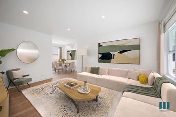 Los Angeles apartment for rent - A modern living room with a large painting on the wall and a coffee table in the center.