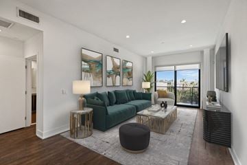 Los Angeles apartment for rent - a living room with a green couch and a sliding glass door