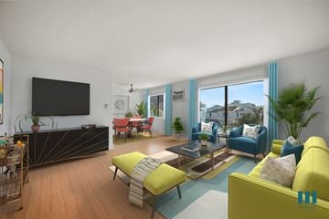 Los Angeles apartment for rent - A living room with a yellow couch and a television on the wall.