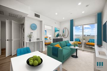 Los Angeles apartment for rent - A living room with a white table and a bowl of green apples on it.