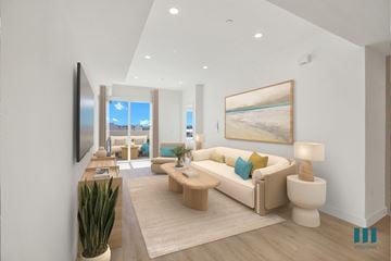 Los Angeles apartment for rent - A living room with a large painting on the wall and a couch with a green pillow.