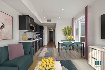 Los Angeles apartment for rent - A modern living room with a green couch and a dining table set up.