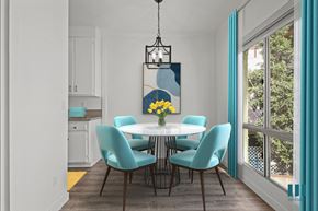 Los Angeles apartment for rent - A dining room with a white table and blue chairs.