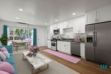 West Hollywood apartment for rent - a living room with a couch and a kitchen with stainless steel appliances