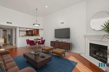 Los Angeles apartment for rent - a living room and dining room with a fireplace and a television