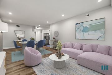Los Angeles apartment for rent - a living room with a pink couch and a table with chairs