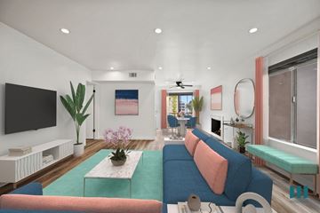 Los Angeles apartment for rent - A living room with a blue couch and a television on the wall.